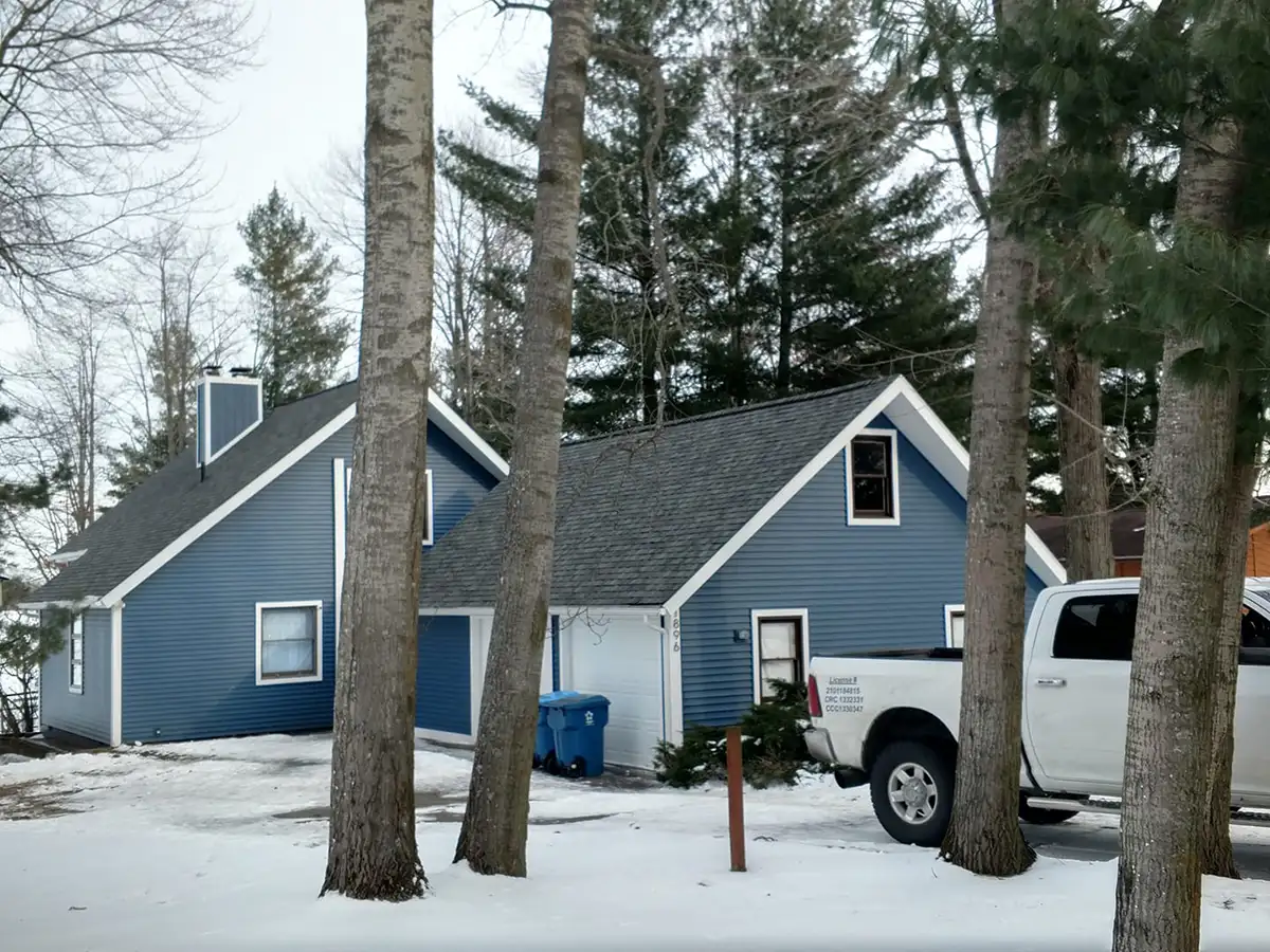 Roofing crew completing a roof replacement in Beaverton Michigan
